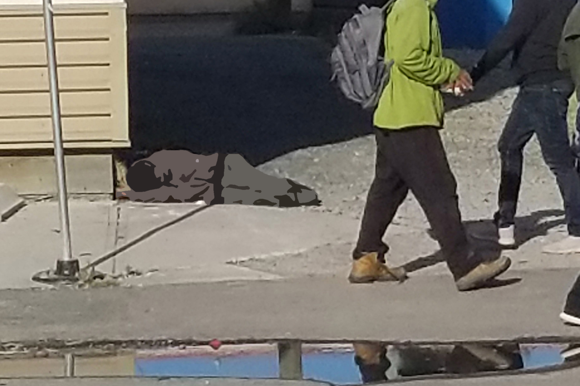 Person asleep on streets of downtown Yellowknife, a too common occurrence.